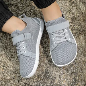 Kids breathable mesh sneakers in light grey on stone background with velcro straps