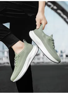 Close-up of lightweight sage green breathable mesh running shoe with thick white EVA sole