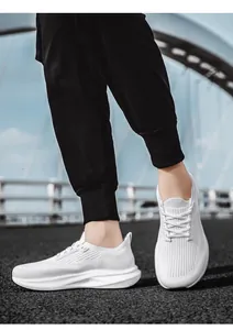 Detail view of white breathable mesh sneakers worn outdoors with anti-slip rubber soles