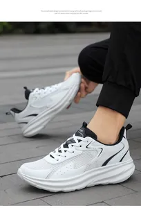 Close-up of black and white mesh running shoes worn on a textured gray stone pavement