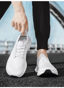 Macro shot of white breathable knit running shoe with thick cushioned sole on outdoor track