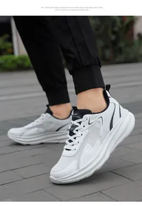 Detail of white men's running shoe with mesh fabric and thick cushioned sole on feet