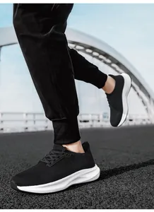 Close-up of black breathable mesh sneakers with thick white shock-absorbing soles