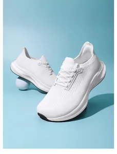 Close-up of white breathable mesh sneakers with thick EVA sole on blue background