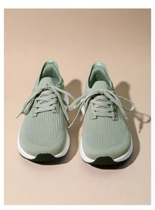 Top-down view of mint green knit sneakers with breathable fabric and white chunky sole