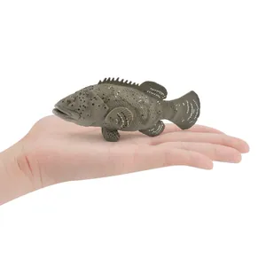 Realistic grouper fish model toy with detailed textures held in palm for scale