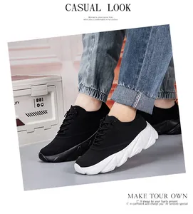 Detail of breathable knit running shoes with white wavy soles and black mesh fabric