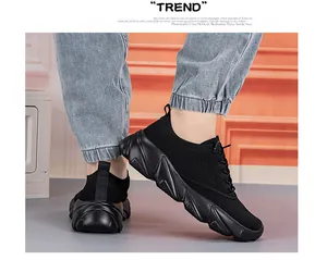 Detail of black breathable mesh upper and thick geometric rubber sole on running shoes