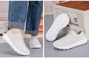 Detail of breathable mesh upper and non-slip geometric thick sole on beige walking shoes