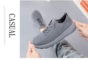 Detailed macro view of grey breathable knit mesh upper and thick soft foam sole on sneakers