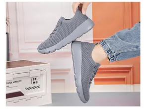 Detail of grey knitted mesh fabric and thick EVA foam sole on breathable sport sneakers