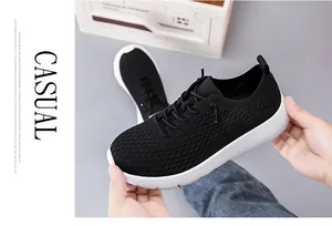 Close-up showing the soft flexibility and lightweight breathable knit of the black shoe