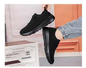 Detail showing breathable black fly-knit upper and thick shock-absorbing sole on sneakers