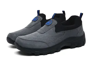 Nahaufnahme grauer Slipper mit dicken Gummisohlen und rutschfestem Profil-Design