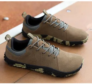 Detailed view of brown suede texture with durable cross-stitching on men's casual outdoor shoe