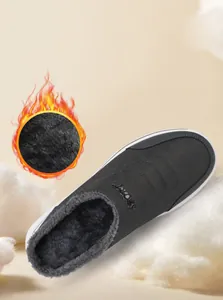 Close-up of thick plush faux fur lining inside deep gray winter slip-on thermal shoes