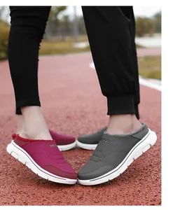 Close-up of waterproof winter slippers with plush lining and sport design for couples