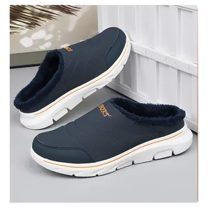 Detail of warm winter mule with blue plush lining and orange sport logo accents