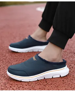 Detail of blue winter mule shoe with warm plush lining and orange sport embroidery