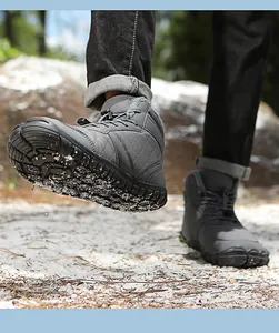 Macro view of grey waterproof snow boots showing the thick fur lining and toggle laces