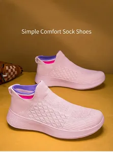 Detailed close-up of pink breathable knit running shoes with elastic sock-like design