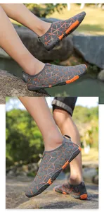 Detalle de zapatos de senderismo transpirables con suela antideslizante y detalles naranja