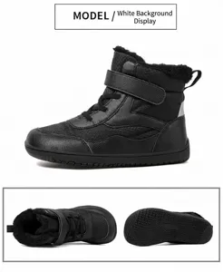 Detail of waterproof black snow boots with warm lining and anti-slip rubber soles