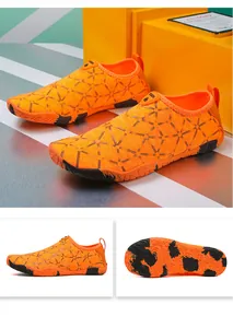 Detalle de la suela de goma antideslizante y malla transpirable en el zapato de trekking naranja