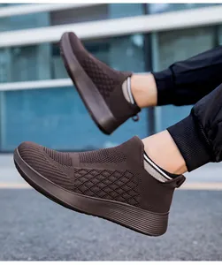 Close-up of brown breathable knitted upper and textured sole on slip-on running shoes