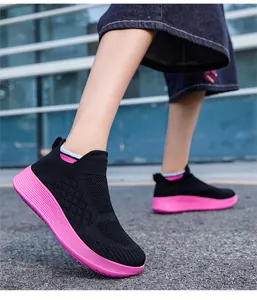 Detail of black knit slip-on sneakers with thick pink cushioned soles for teenagers