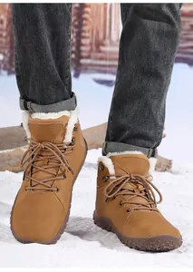 Detail of warm winter snow boots featuring camel suede finish and thick faux fur lining