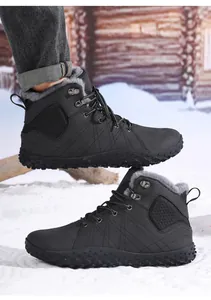 Detail shot of black high-top winter boots with thick grey faux fur lining for men and women