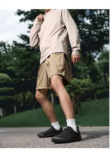 Vue extérieure de chaussures pieds nus noires avec un short cargo kaki et chaussettes