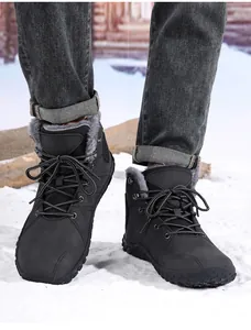 Close-up of black winter snow boots with thick faux fur lining and anti-slip rubber sole