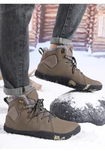 Close-up of waterproof winter boots with plush lining and anti-slip soles on snow