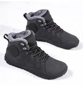 Detail of warm black winter snow boots with thick grey faux fur lining and anti-slip rubber sole