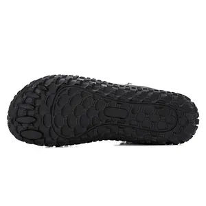 Detail of black non-slip rubber outsole with five-toe barefoot structure and grip patterns