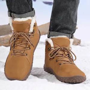 Winter warm men's snow boots with plush lining and non-slip soles on a snow surface