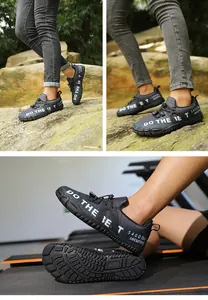 Detail of non-slip rubber sole and breathable fabric on black barefoot hiking shoes