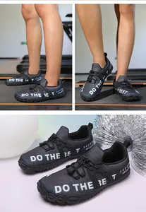 Detail view of dark grey barefoot water shoes with elastic laces and slogan print