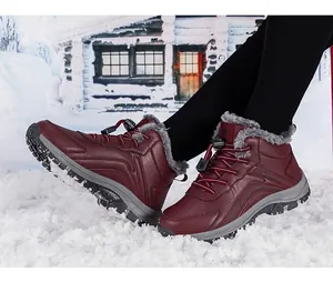 Detailed view of wine red winter boots featuring thick grey faux fur lining and anti-slip sole