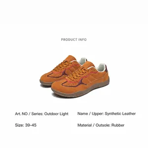 Detail view of tan synthetic leather hiking shoes with rubber sole and contrast stitching