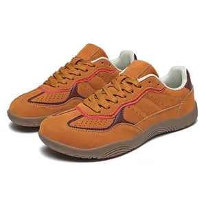 Brown and orange suede hiking shoes with breathable perforations and lace-up closure