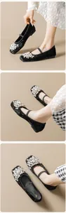 Detail of black velvet Mary Jane flats with clustered pearls and beaded toe decoration