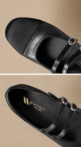 Détails des ballerines Mary Jane noires montrant le cuir texturé et la boucle strass