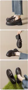 Detail of dark brown leather platform loafers with retro gold buckles and soft sole