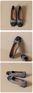 Detail of grey suede ballet flats with black contrast toe and bow decoration