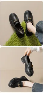 Detail view of platform loafers with matte black leather and gold buckle accents