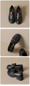 Detail view of black leather platform loafers featuring elegant gold metal D-buckle detail