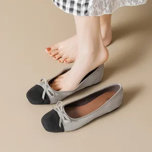 Elegant ballet flats for women featuring a grey suede upper and black cap-toe design